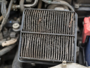 Clogged air filter, a common cause of engine misfires, restricting airflow and affecting engine performance.