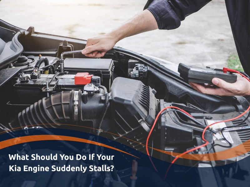 Image showing a mechanic diagnosing a Kia engine stalling problem with a multimeter on an open car engine. The engine bay is visible, with wires and components.